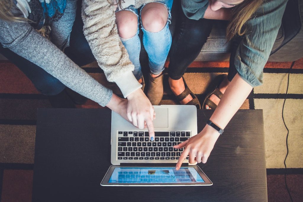 People pointing at a computer