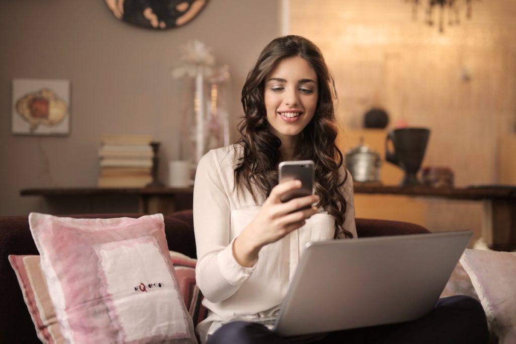 Woman virtual home buying from her couch