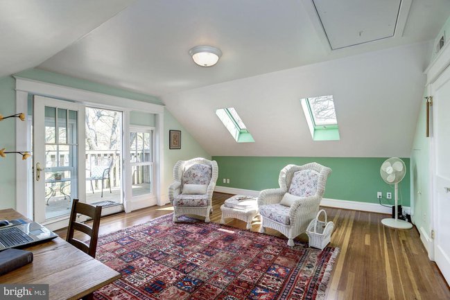 top floor bedroom with skylights and a balcony walkout