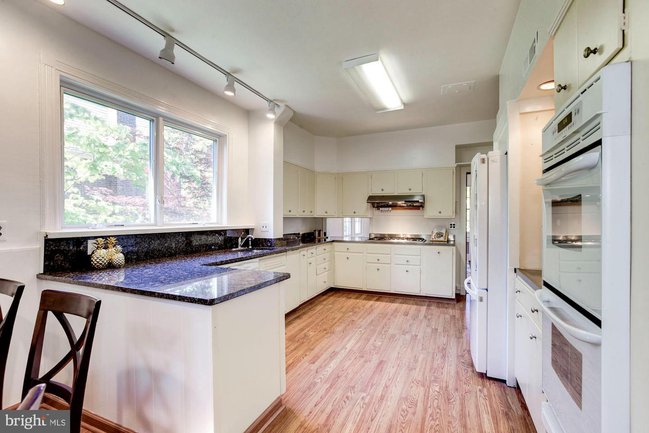 a gourmet kitchen with white cabinets