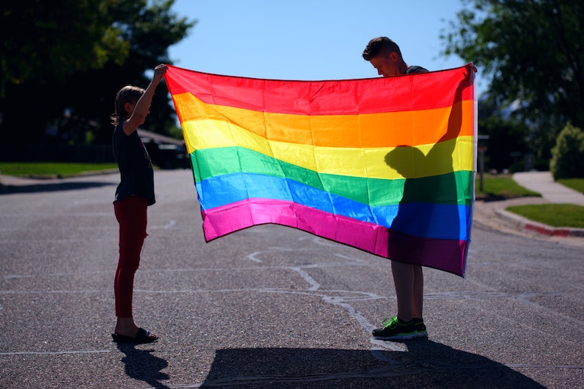 holding a flag for pride month