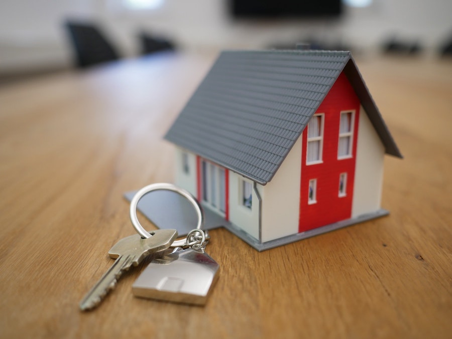 a model house with keys next to it